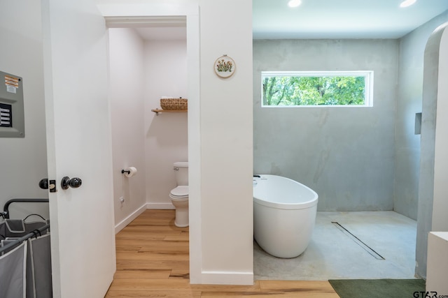 15683 Crk 472, Tyler, TX 75706 - bathroom featuring a soaking tub and wood finished floors