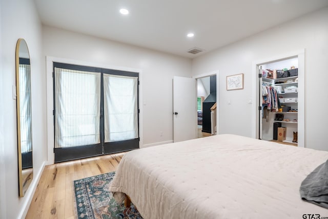 15683 Crk 472, Tyler, TX 75706 - bedroom featuring light wood-type flooring, recessed lighting, a spacious closet, french doors, and access to outside