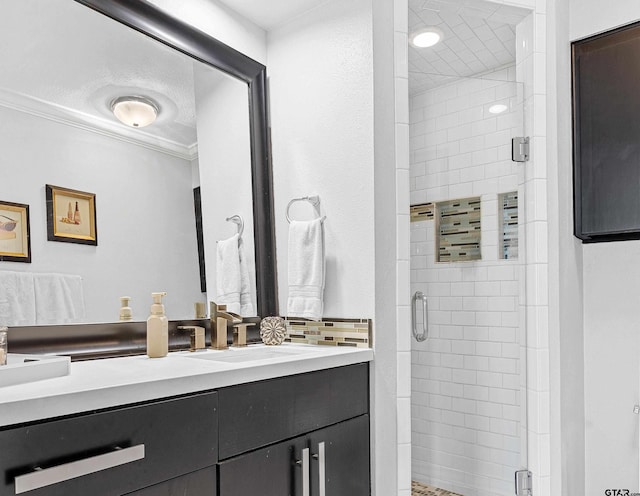 bathroom featuring vanity, an enclosed shower, and crown molding