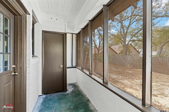 unfurnished sunroom featuring wooden ceiling