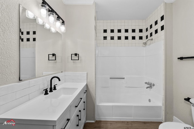 bathroom with vanity, wood-type flooring, tiled shower / bath combo, and tasteful backsplash