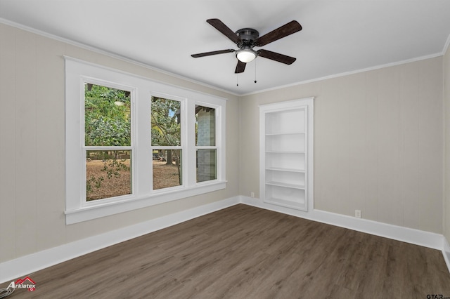 unfurnished room with ceiling fan, built in features, ornamental molding, and dark wood-type flooring