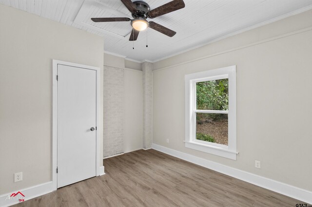 empty room featuring ceiling fan, light hardwood / wood-style flooring, and wooden ceiling