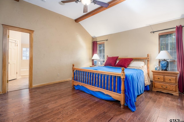 bedroom with hardwood / wood-style flooring, ceiling fan, connected bathroom, and lofted ceiling with beams