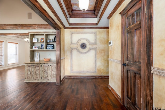 hall with dark hardwood / wood-style flooring, a tray ceiling, and crown molding