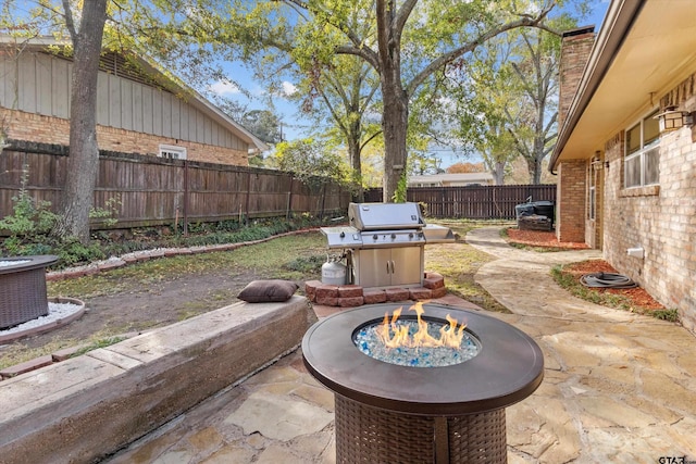 view of patio / terrace featuring an outdoor fire pit