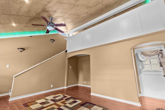 unfurnished living room with ceiling fan and hardwood / wood-style floors