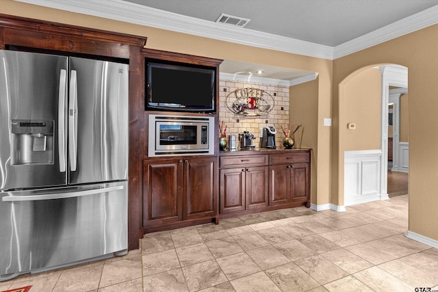 kitchen with tasteful backsplash, crown molding, and stainless steel appliances