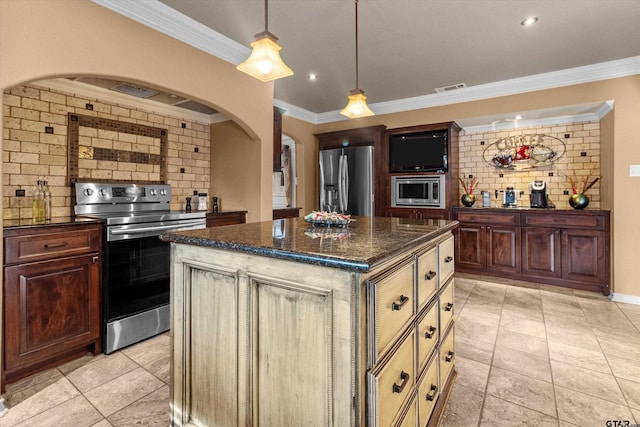 kitchen with backsplash, a kitchen island, crown molding, and stainless steel appliances