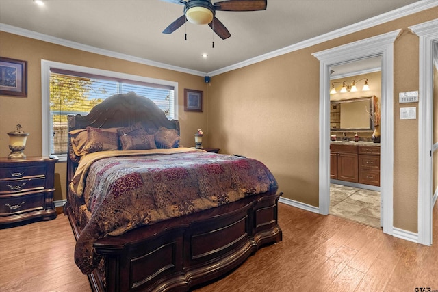 bedroom featuring ensuite bath, light hardwood / wood-style flooring, ceiling fan, and ornamental molding