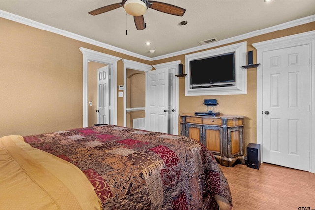 bedroom featuring ceiling fan, light wood-type flooring, and ornamental molding