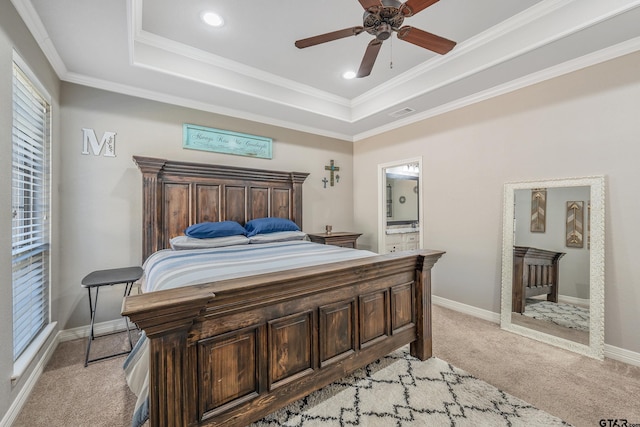 carpeted bedroom with ceiling fan, a raised ceiling, and ornamental molding