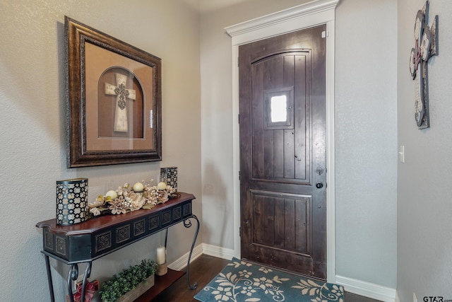 entryway with dark hardwood / wood-style floors