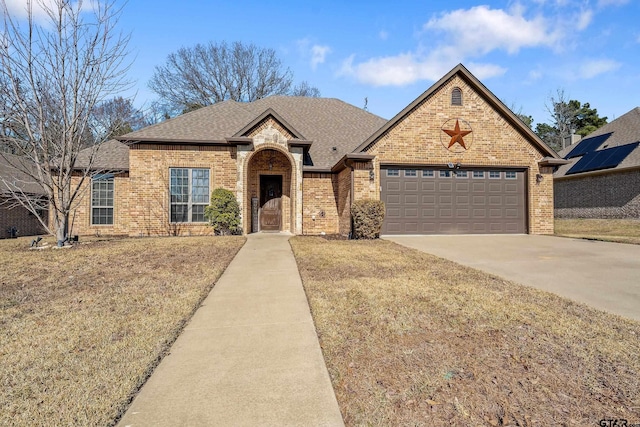 view of front of property with a garage and a front lawn