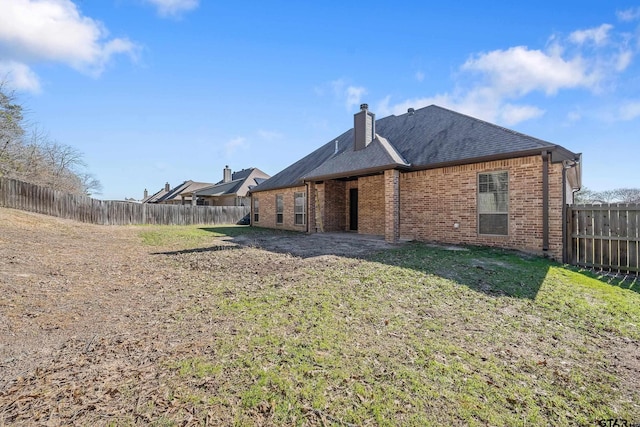 rear view of property with a yard