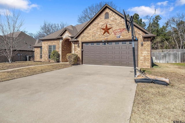 view of property featuring a garage and a front yard