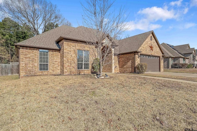 view of front of house featuring a garage and a front yard