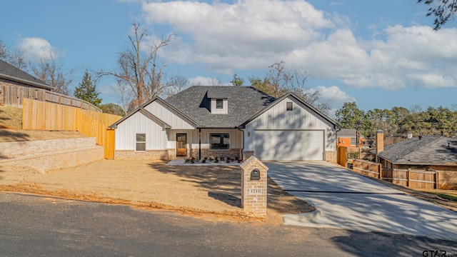 view of front facade featuring concrete driveway, roof with shingles, a garage, and fence