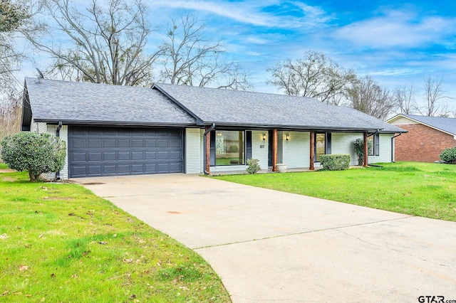 ranch-style house with roof with shingles, a porch, concrete driveway, an attached garage, and a front yard