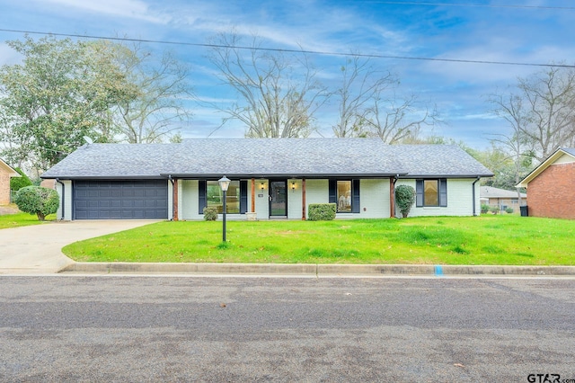 view of front of property featuring roof with shingles, a front lawn, concrete driveway, covered porch, and an attached garage