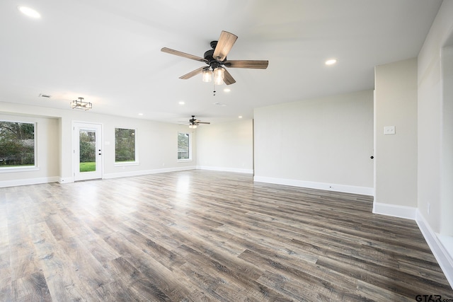 empty room featuring recessed lighting, wood finished floors, a ceiling fan, and baseboards