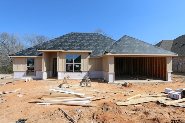 rear view of property featuring a garage