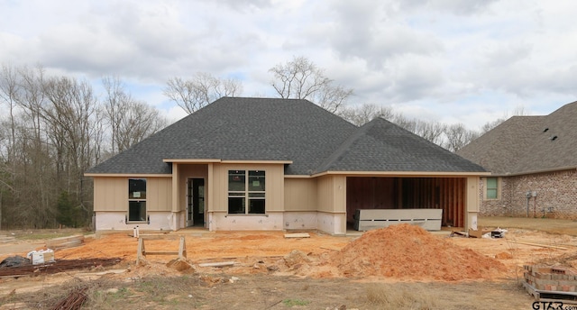 view of front of house featuring board and batten siding, an attached garage, and a shingled roof