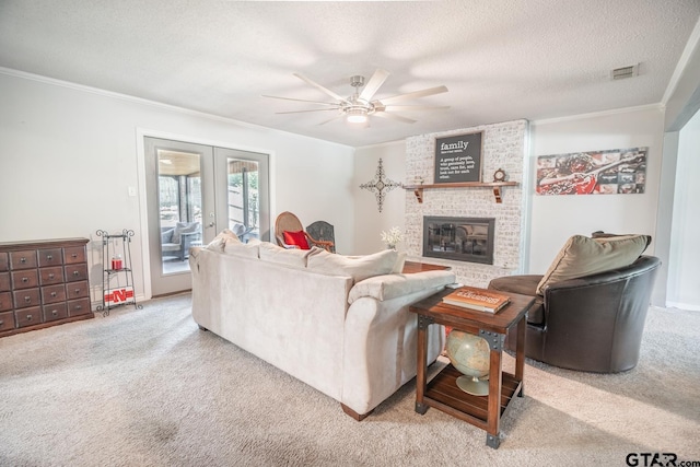 living room featuring french doors, a textured ceiling, light carpet, a brick fireplace, and ceiling fan