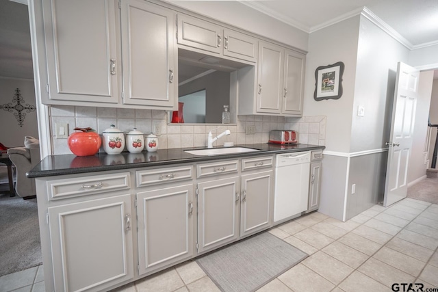 kitchen featuring tasteful backsplash, sink, white dishwasher, and light tile patterned floors