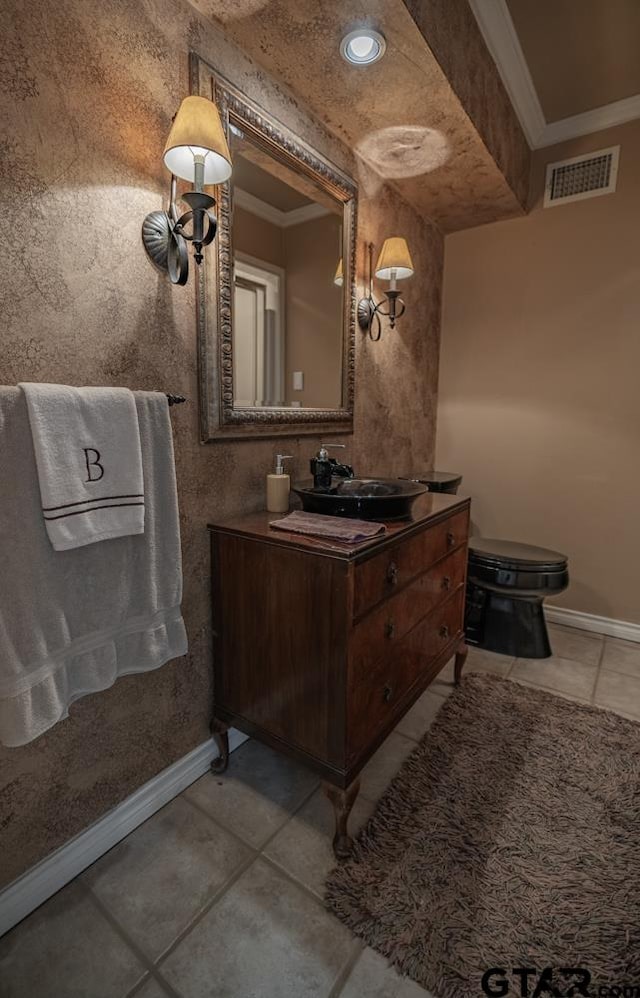 bathroom featuring toilet, vanity, tile patterned flooring, and crown molding