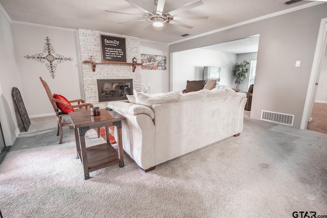 carpeted living room with a textured ceiling, a fireplace, ceiling fan, and crown molding