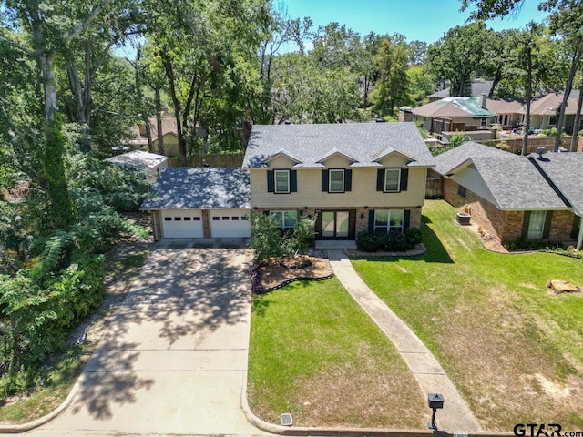 view of front of home featuring a garage and a front yard