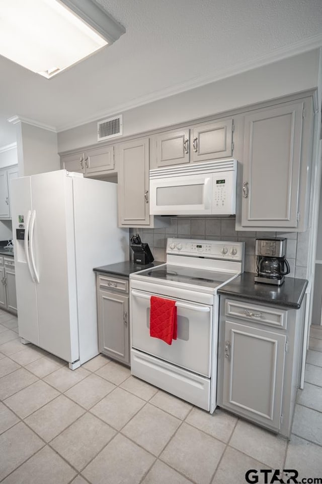 kitchen with white appliances, gray cabinetry, light tile patterned flooring, and ornamental molding