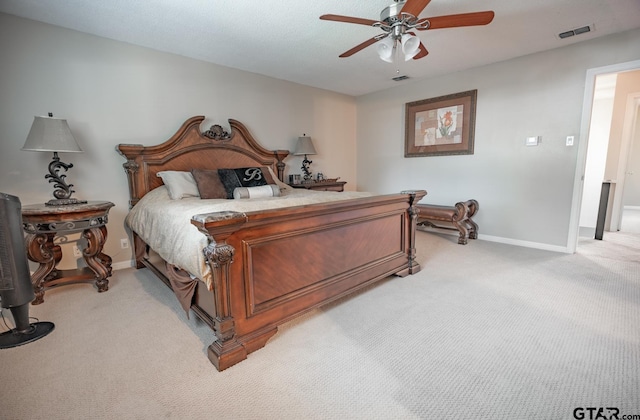 bedroom with ceiling fan and light carpet