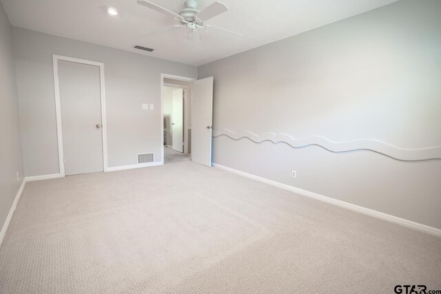 unfurnished bedroom with light carpet and ceiling fan