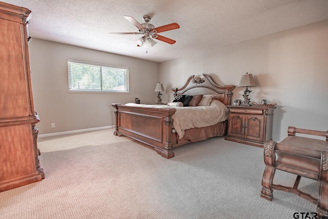 carpeted bedroom featuring a textured ceiling and ceiling fan