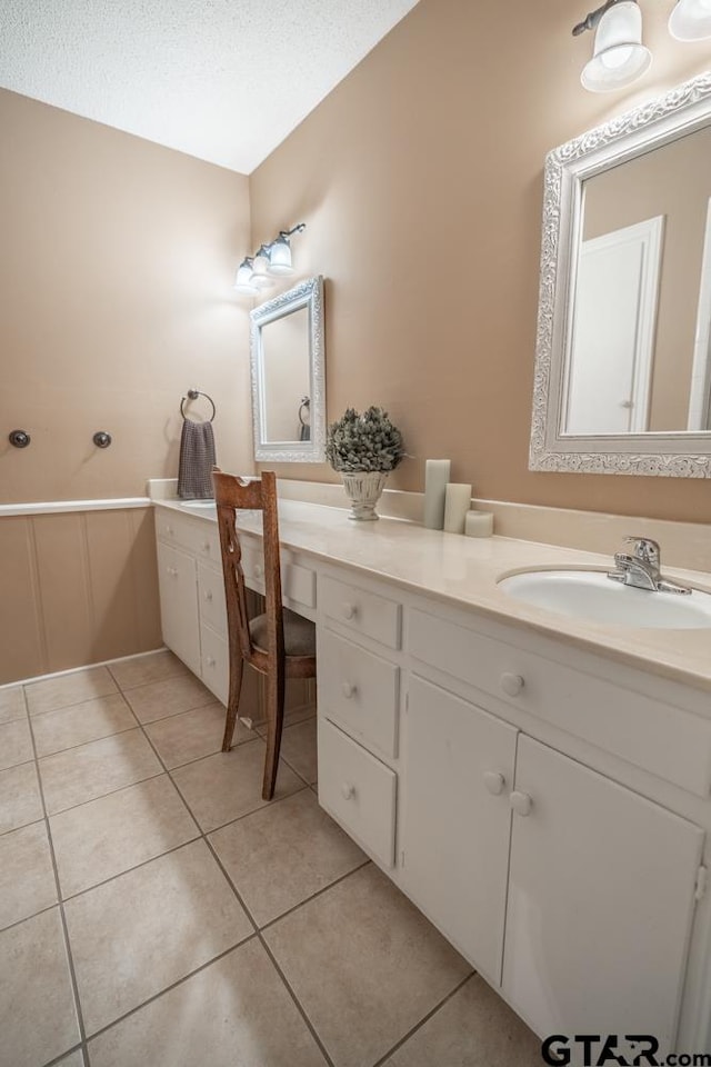 bathroom featuring vanity, tile patterned flooring, and a textured ceiling