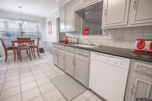 kitchen featuring an inviting chandelier, sink, white dishwasher, and light tile patterned floors