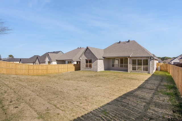 rear view of property with a lawn