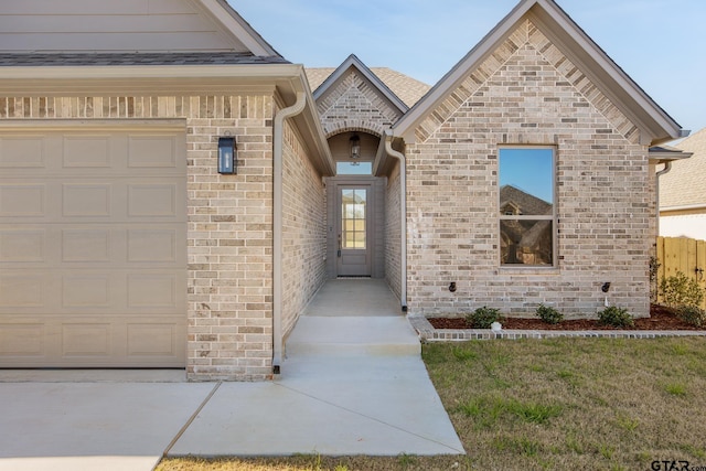 view of exterior entry with a garage