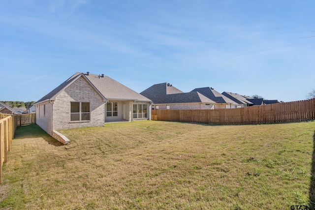 back of property featuring a lawn