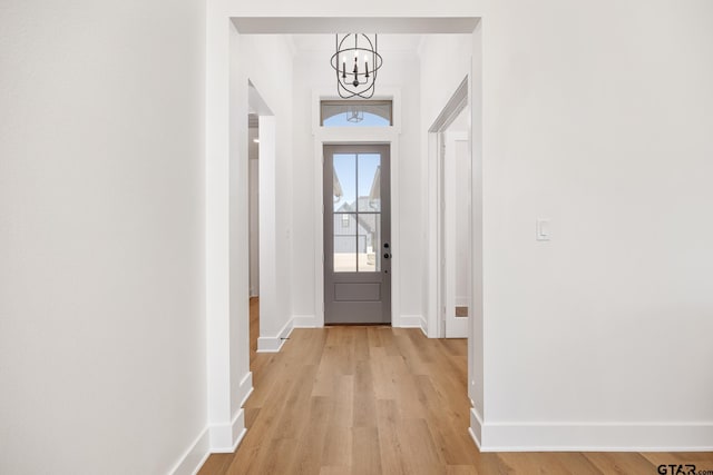 entryway featuring a notable chandelier and light wood-type flooring