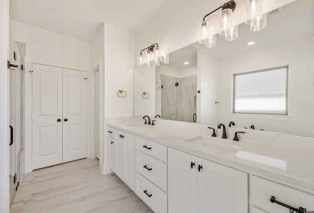 bathroom featuring vanity and a shower with door