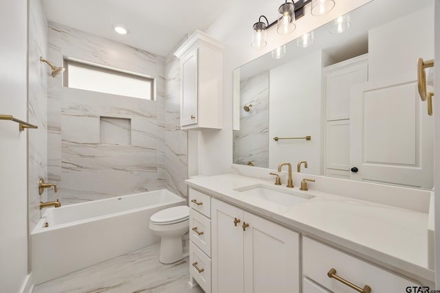 full bathroom featuring vanity, tiled shower / bath combo, and toilet