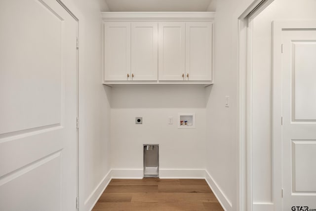 laundry room featuring hookup for an electric dryer, hookup for a washing machine, light wood-type flooring, and cabinets