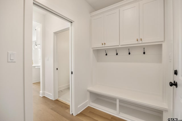 mudroom with light hardwood / wood-style floors