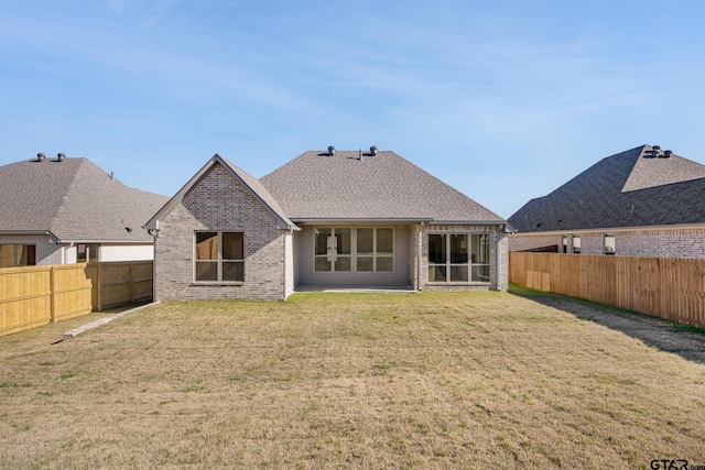 rear view of house featuring a yard