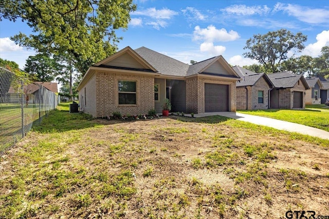 2609 Tulsa St, Tyler, TX 75702 - ranch-style home featuring an attached garage, brick siding, and concrete driveway