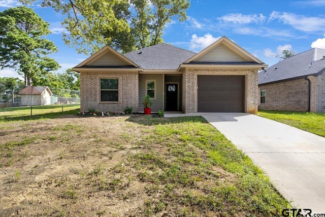 2609 Tulsa St, Tyler, TX 75702 - ranch-style house featuring brick siding, an attached garage, and driveway