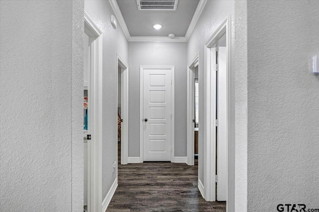 2609 Tulsa St, Tyler, TX 75702 - hallway with a textured wall, crown molding, and dark wood-type flooring